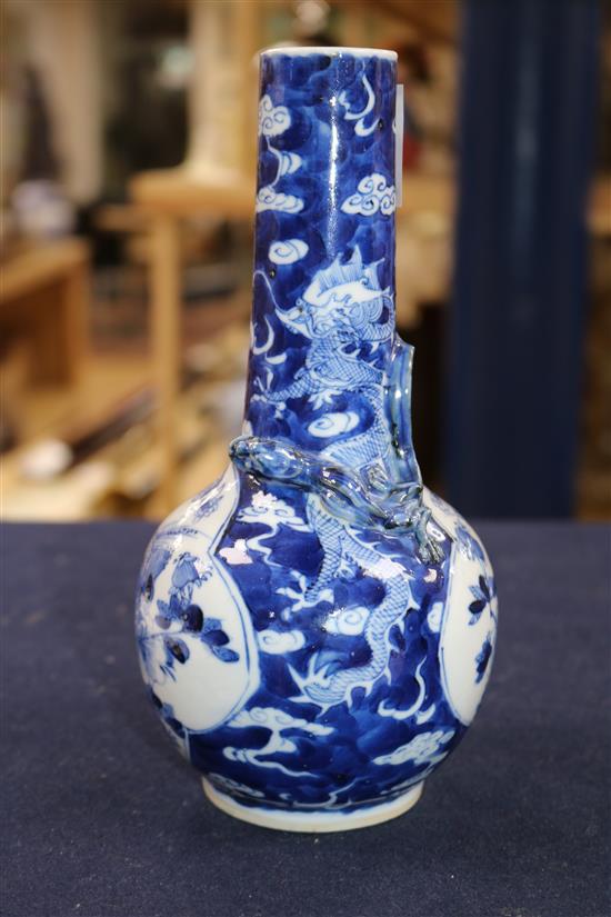 A blue and white vase painted with dragons and birds